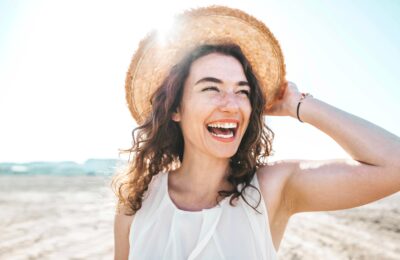 happy young woman smiling at the beach