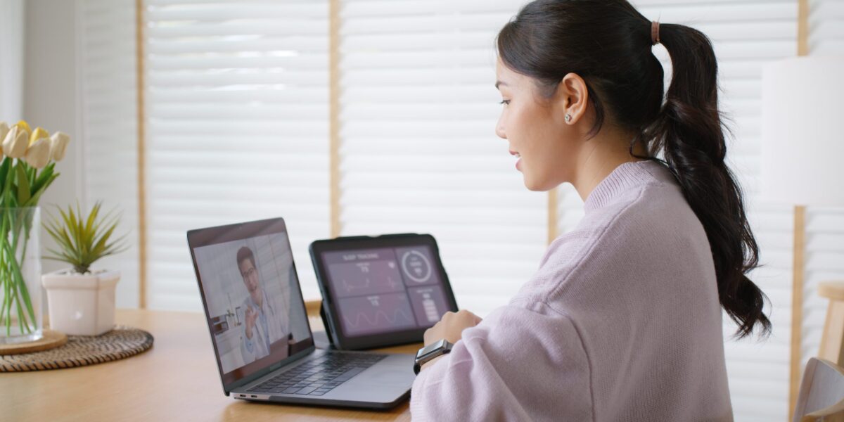 young asian woman on video appointment