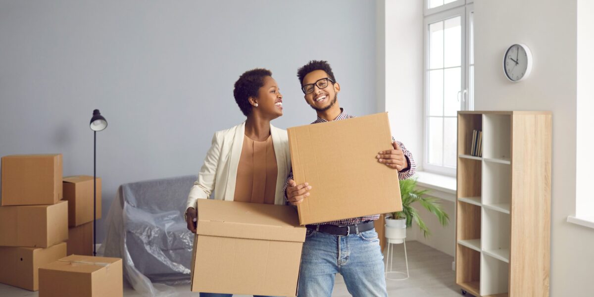 portrait of ethnic couple celebrating a move