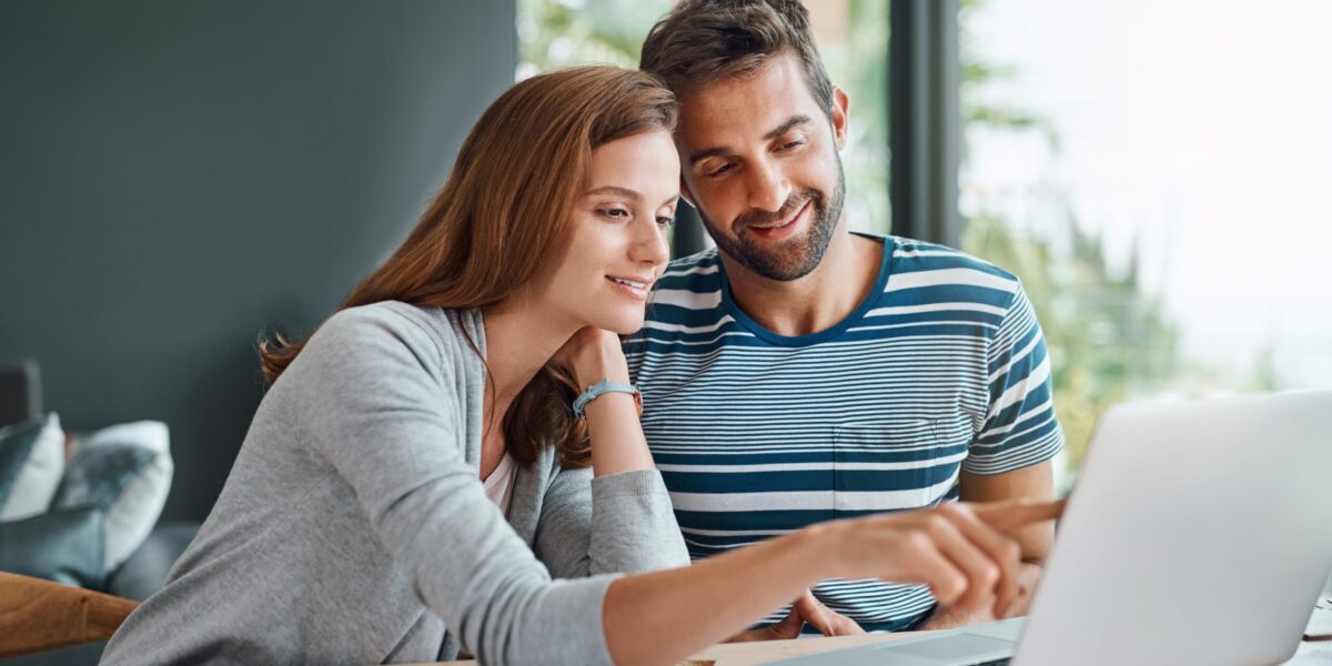 young couple looking at a laptop and planning