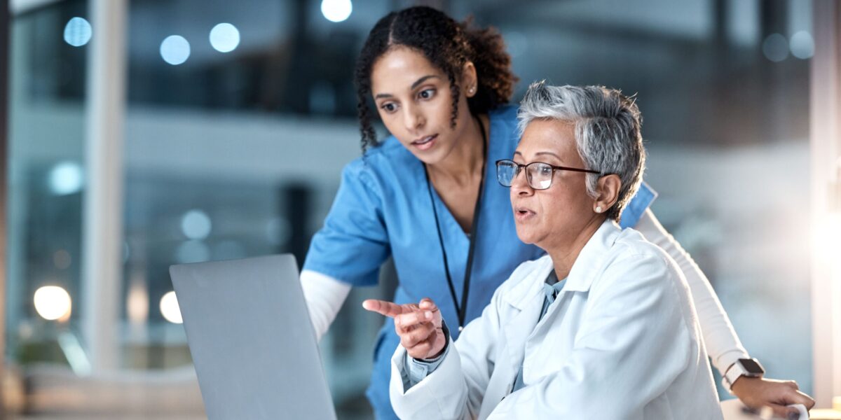 doctor and nurse on laptop planning