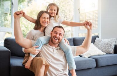 smiling family on sofa