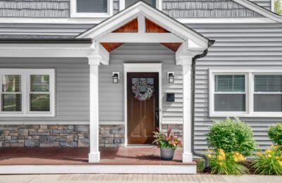 a gray modern house with a front porch